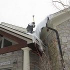 jason_greene_of_arlington_roofers_breaks_up_ice_at_burr_and_burton_academy.jpg